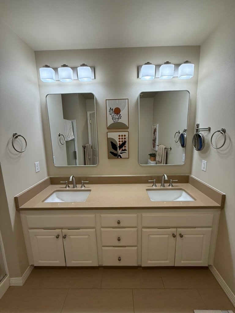 Finished blue-gray bathroom remodel with recessed medicine cabinets