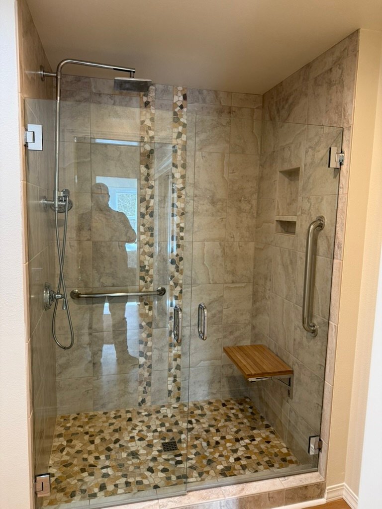Finished tiled shower with glass enclosure