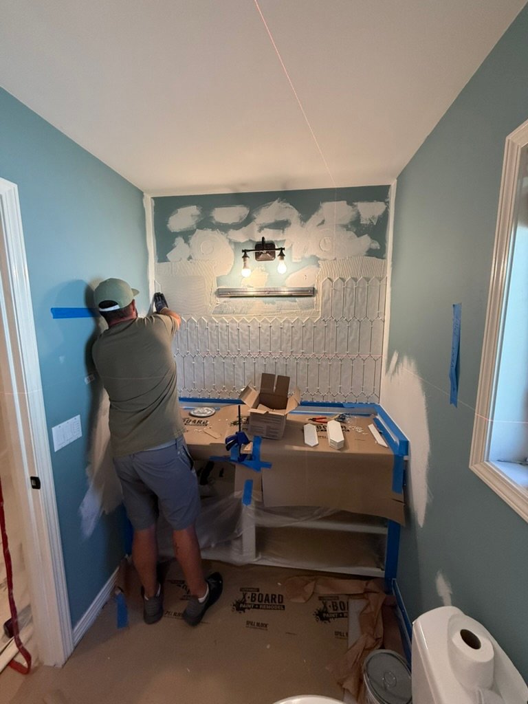 Portland contractor installing new tile on bathroom vanity wall